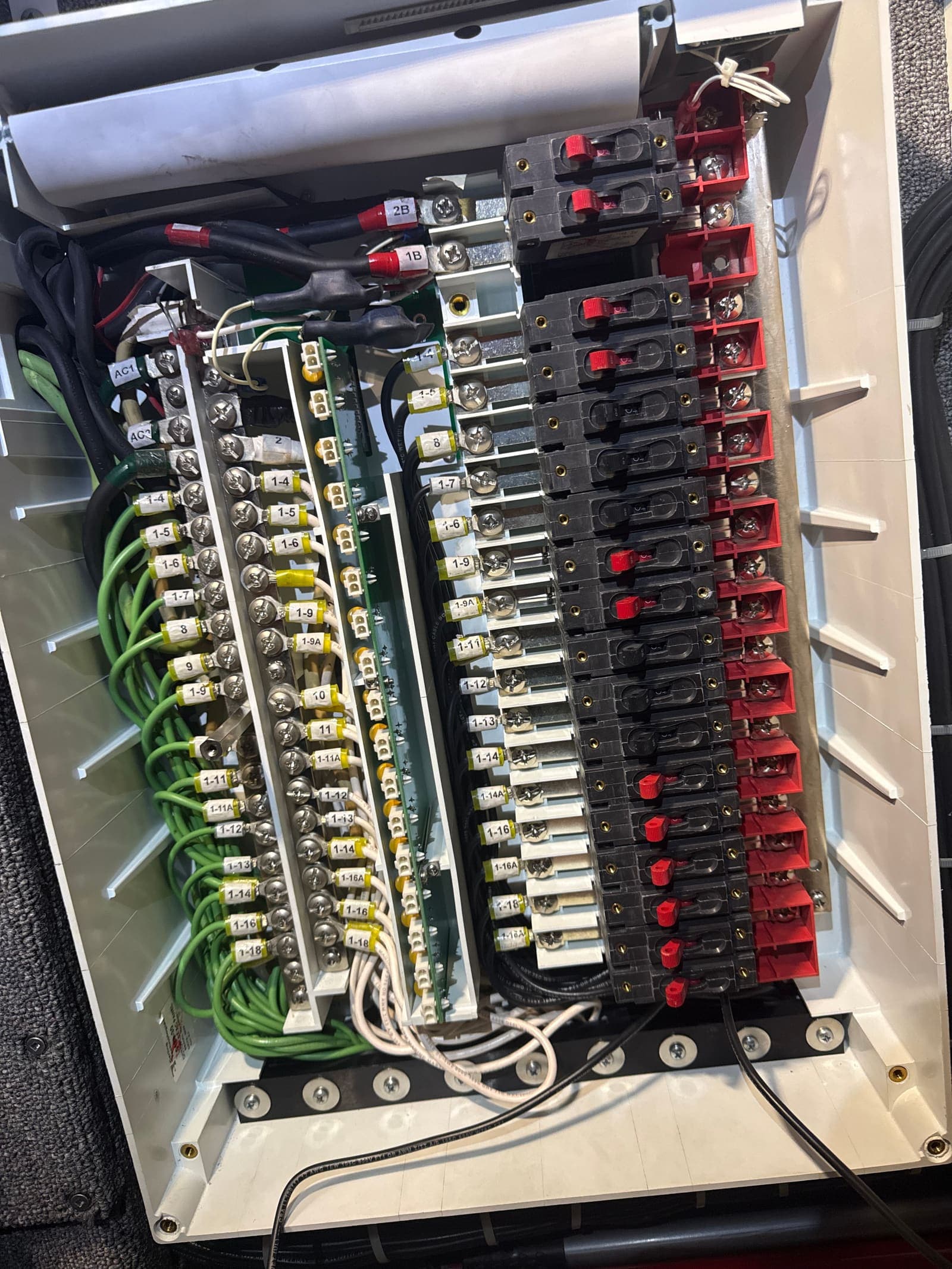 Open RV electrical breaker panel with labeled circuits and professional wiring