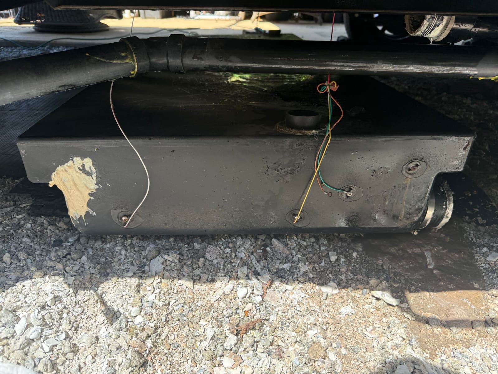 Holding tank and under-chassis plumbing during mobile RV service